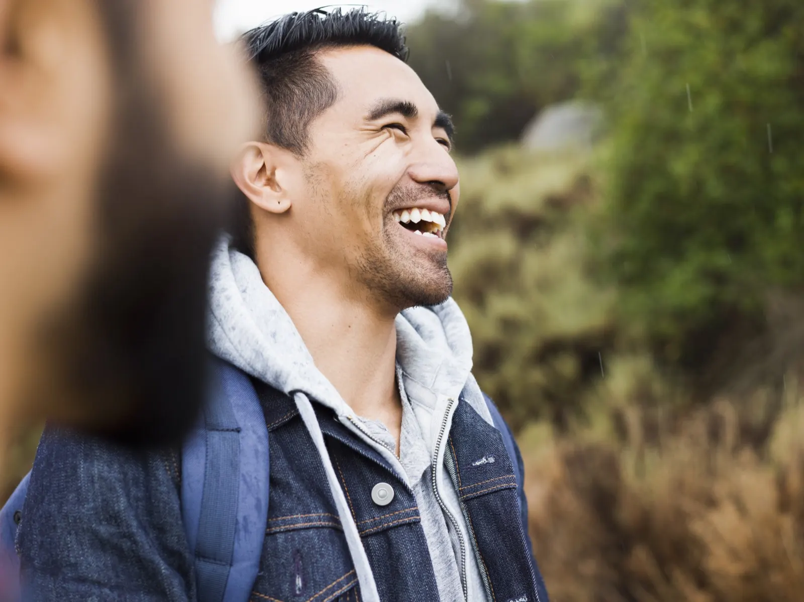 Two friends laughing together outdoors