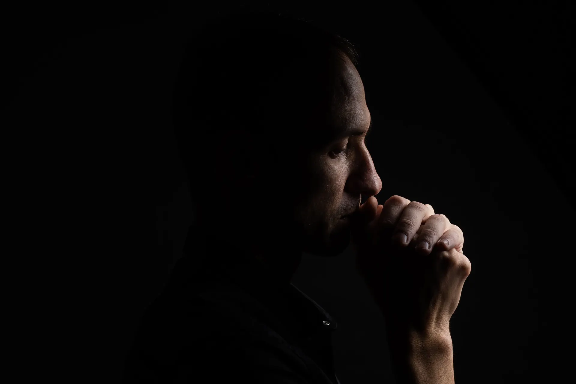 A young man sitting alone in thought
