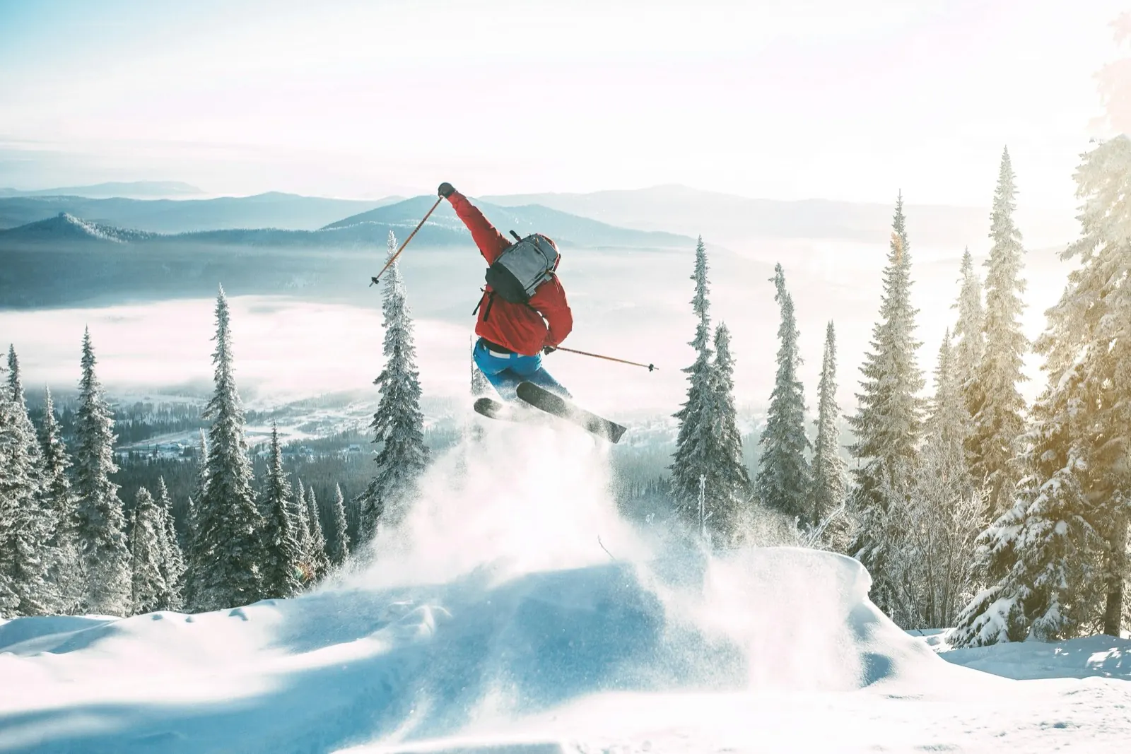 A skier carving through fresh powder